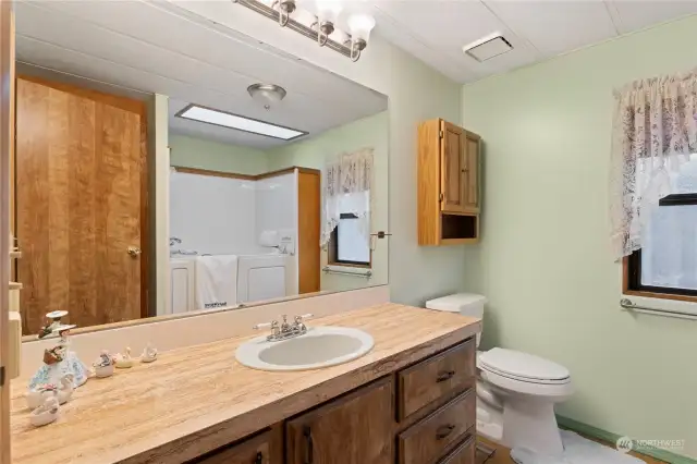 The primary bathroom features a quite new and upscale jetted safety step-in tub, which you see reflected in the mirror.