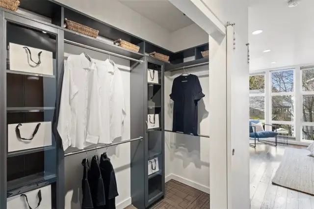 Primary walk-in closet with barn door and custom built-ins.