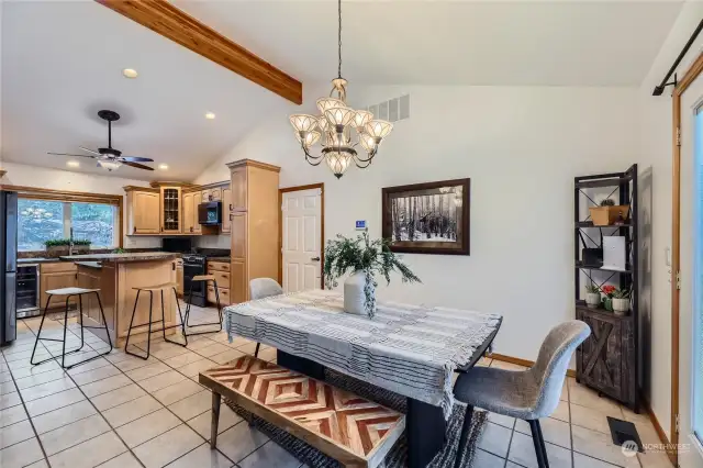 This bright and open dining area features French doors leading to the enormous deck, creating a seamless indoor-outdoor flow for entertaining and enjoying the views.