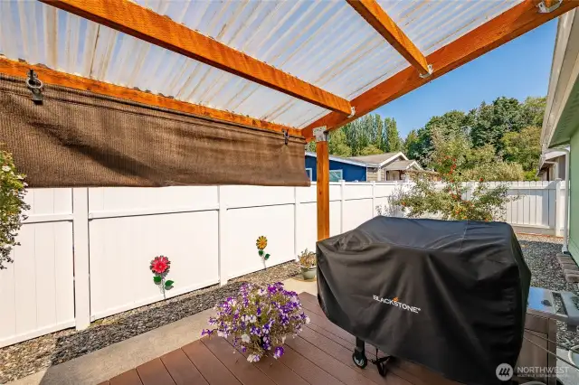Low maintenance back yard with covered patio and covered deck. Fully fenced all the way around the other side of the home. Honey Crisp apple tree beyond