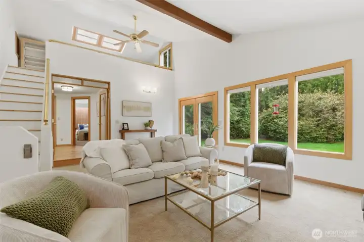 The open, voluminous Family Room also captures the private setting .  To the left, in the photo, the stairs lead up to a secret storage area and loft...  easily used as an office, or homework area.
