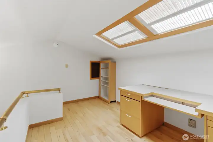 This loft area has many possibilities for use ...  Office? Crafting? Homework?   When you view this home check out the secret storage!