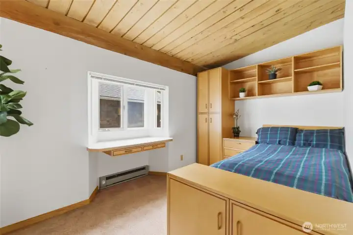 The second bedroom has practical, brilliantly crafted built ins.