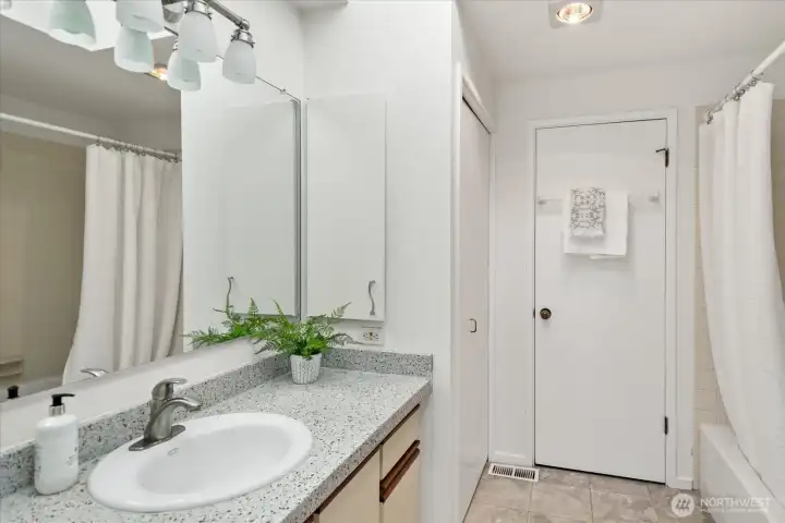 Full bath is light and bright and shared between the two bedrooms