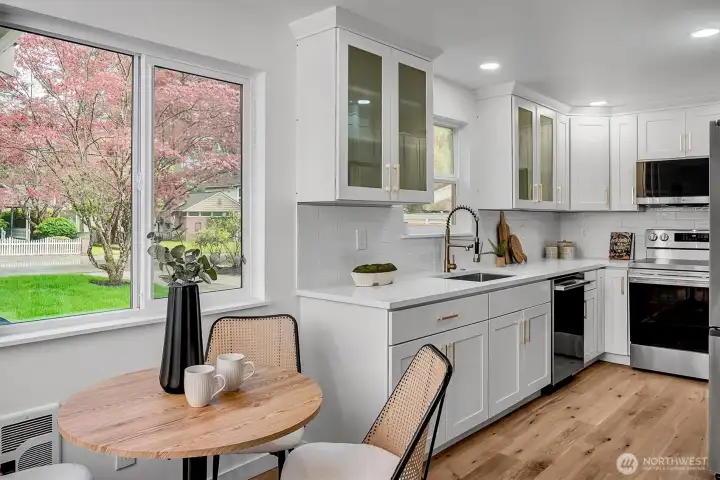 Kitchen features granite countertops and cabinets to ceiling.