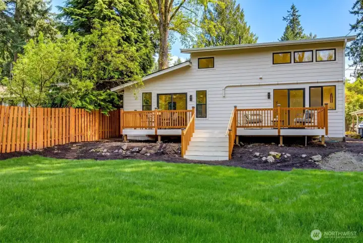 Backyard with expansive deck for outdoor living.