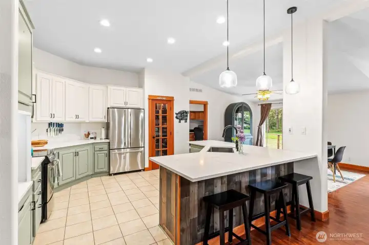 Gorgeous kitchen with quartz countertops and SS appliances.