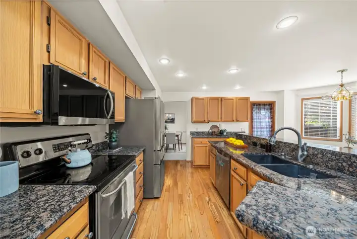 Remodeled kitchen with granite countertops - stainless steel appliances.