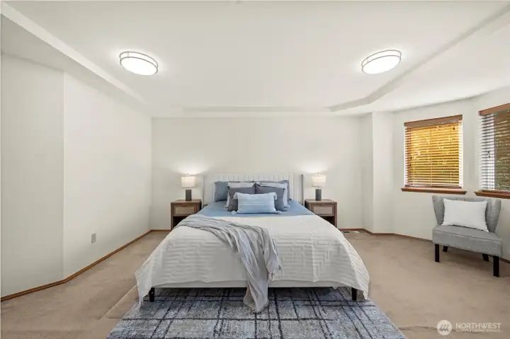 Primary bedroom with space for a sitting area.