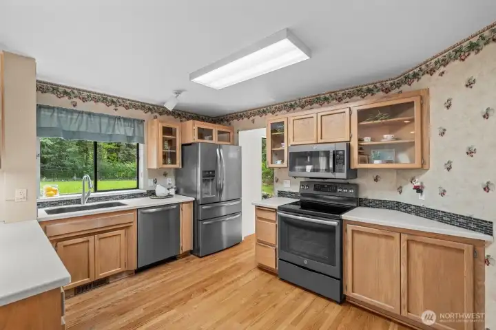 Kitchen has solid surface countertops and undermount sink plus all the appliances stay - range has a convection oven.