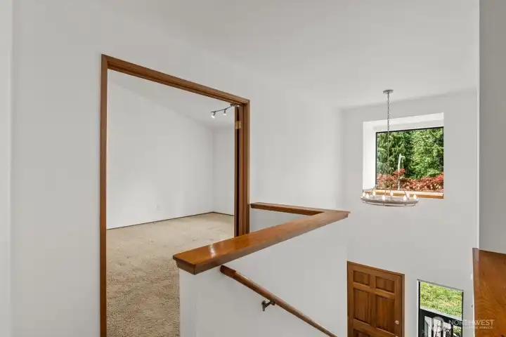 Upstairs landing to the double door primary bedroom.