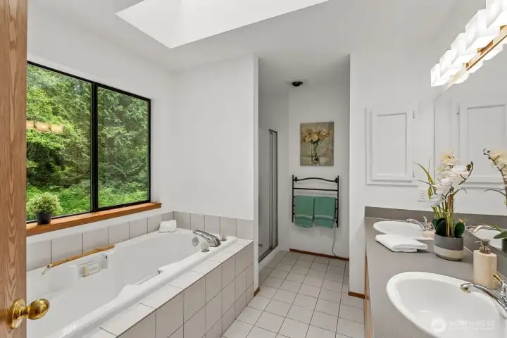 Primary en-suite, window overlooks the private green back yard.