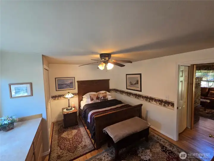 View of primary bedroom from bathroom doorway.