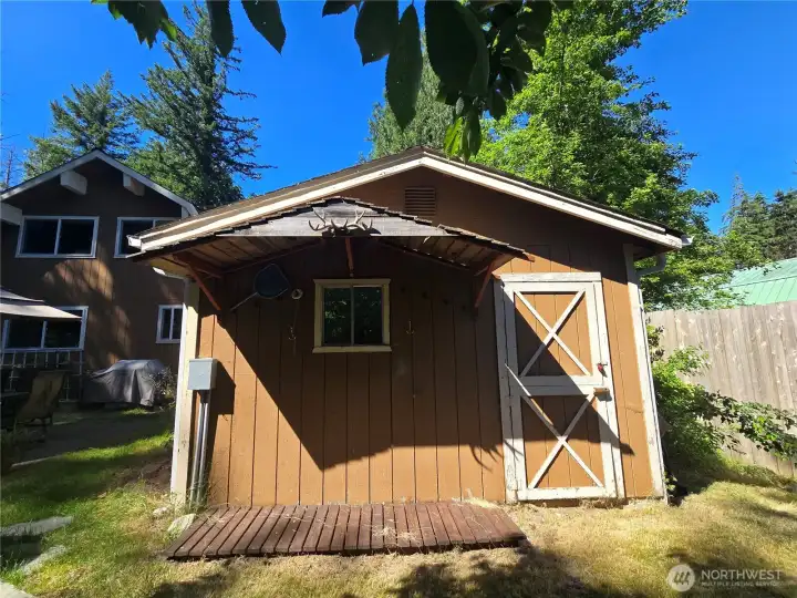 Cute outbuilding is a great shop or shed.