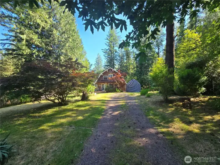Long driveway accommodates multiple cars.
