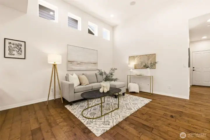 Living Room. Soft neutral tones and a plush area rug create a relaxed gathering space beneath tall clerestory windows. Living Room. Soft neutral tones and a plush area rug create a relaxed gathering space beneath tall clerestory windows.