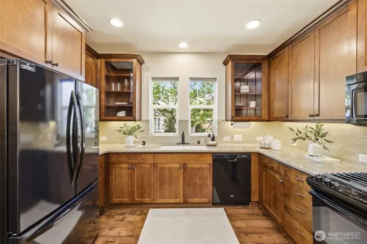 Kitchen. A window above the sink brings in natural light, complemented by tile backsplash and ample cabinetry. Kitchen. A window above the sink brings in natural light, complemented by tile backsplash and ample cabinetry.