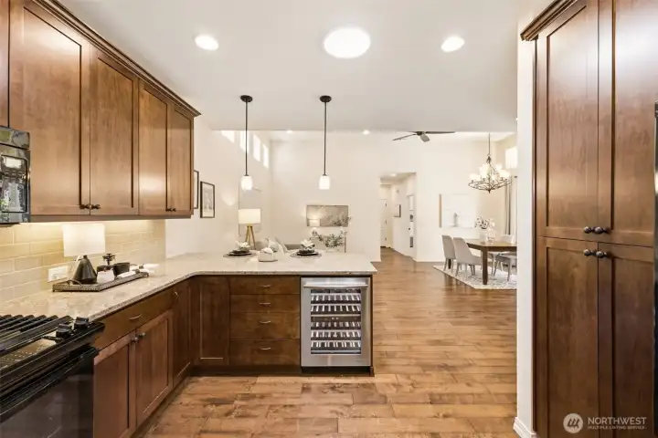 Kitchen. A built-in beverage cooler and open flow to the dining area add convenience for hosting. Kitchen. A built-in beverage cooler and open flow to the dining area add convenience for hosting.