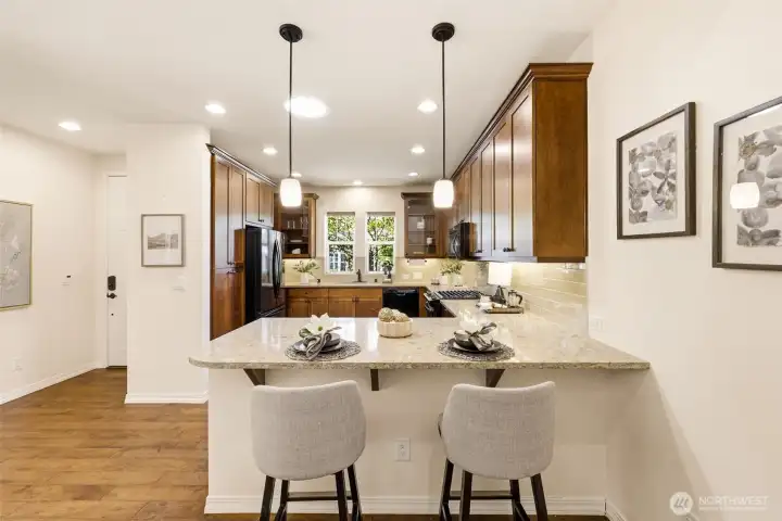 Kitchen Island. Quartz countertops and bar seating offer a casual spot for quick meals or conversation. Kitchen Island. Quartz countertops and bar seating offer a casual spot for quick meals or conversation.