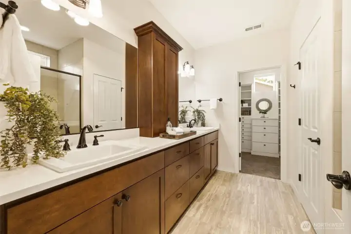 Primary Bathroom. Dual vanities and rich wood cabinetry offer plenty of space to get ready, with direct access to the walk-in closet. Primary Bathroom. Dual vanities and rich wood cabinetry offer plenty of space to get ready, with direct access to the walk-in closet.