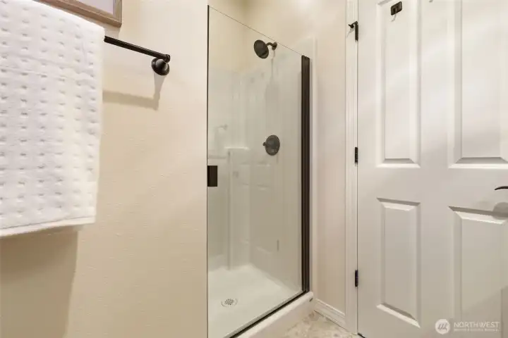 Bathroom. A glass-enclosed shower with tile surround offers a clean, modern finish. Bathroom. A glass-enclosed shower with tile surround offers a clean, modern finish.