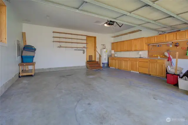 Large, two car garage also has storage and a nice work bench.