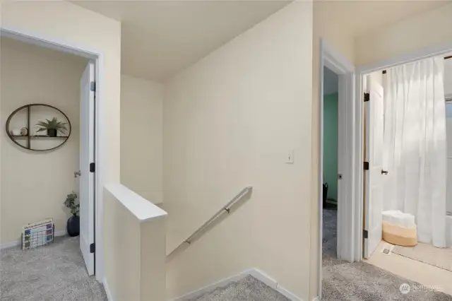 Let's head upstairs to the three bedrooms and full bathroom! The door to the right of the stairs is the large Primary Bedroom next to the bathroom.