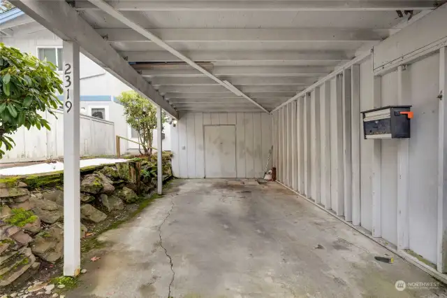 Single-car carport with storage and mailbox. One additional assigned parking space (#15) is next to the visitor parking.