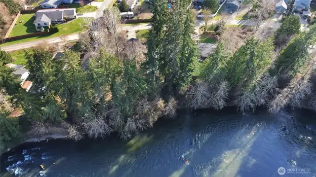 View from air shows high bank river at back yard