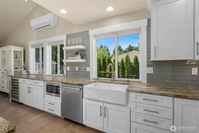 Farm style sing is chic, along with floating shelves, and touches of glass cabinetry