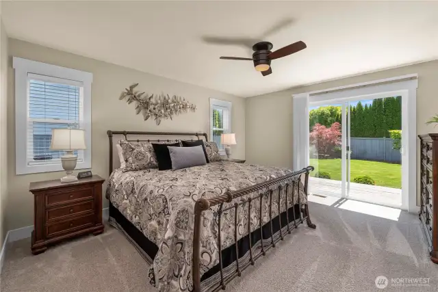 Spacious primary has direct access to the backyard oasis