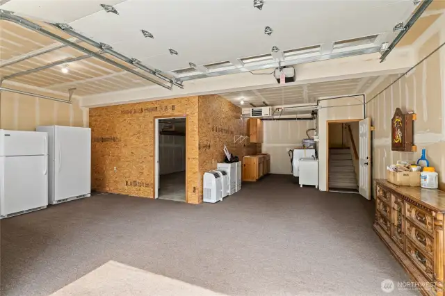 Garage partially enclosed  to accomodate washer, dryer, freezer, cabinets.  Single garage space opens from back side.