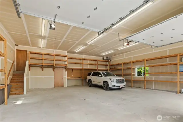 Stairs lead to media & bonus rooms above heated garage, shop.