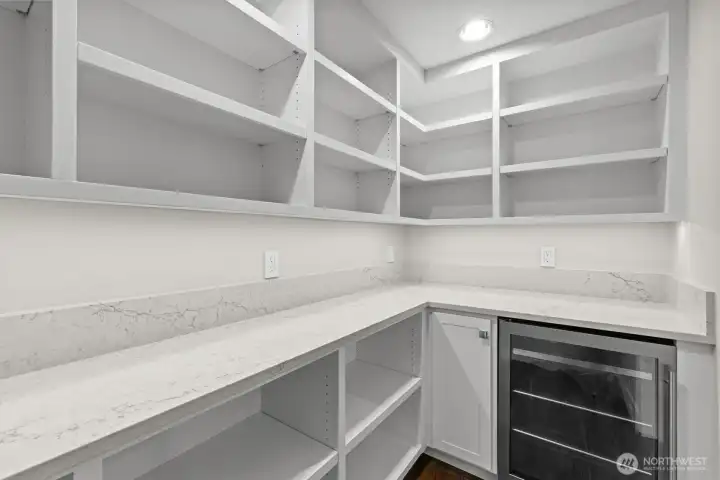 walk in pantry with wine refrigerator and large counter space for  all your kitchen appliances and lots of storage