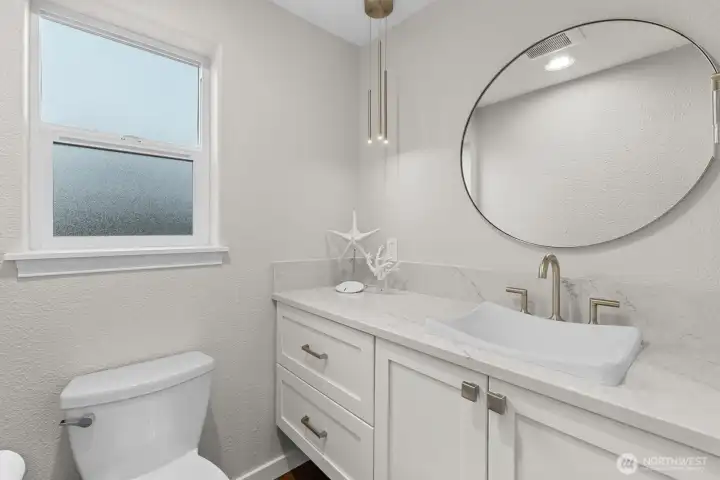 powder room on main level with stylish fixtures