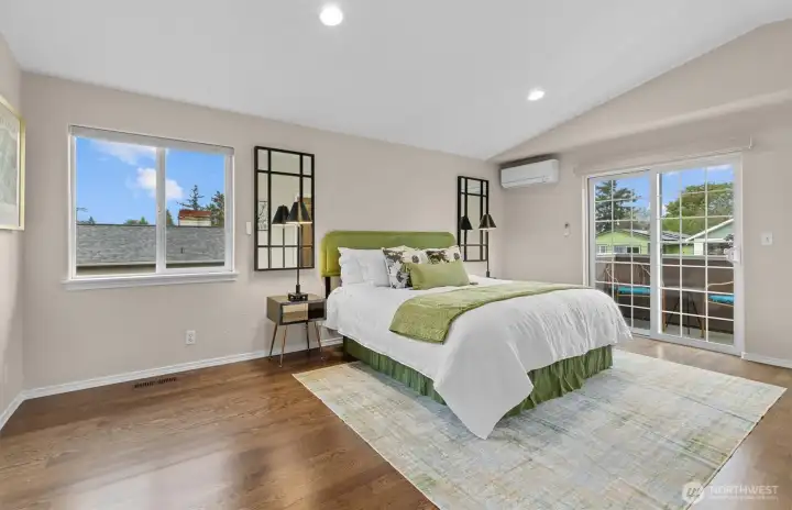 spacious primary bedroom with adjacent deck