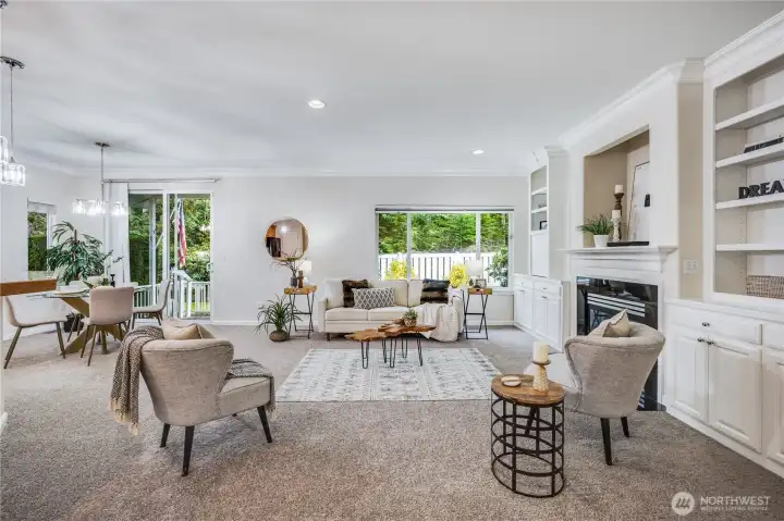 Inside the home, you’re greeted by a warm, inviting great room. Tall ceilings invite ample natural light and views of greenery.