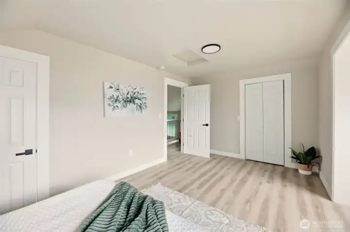 The door on the left leads to en suite bathroom and closet door on the other side of the room.