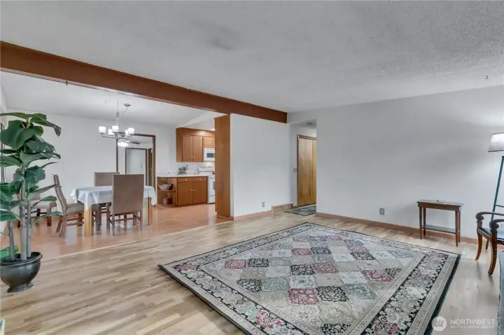 Living room looking towards kitchen. Vaulted ceilings and good nautral light.