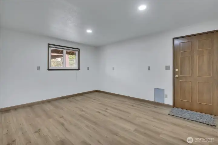 Large extra finished room with door to exterior and plumbing capped off for future use... possible shop/ home office/ gym or...?