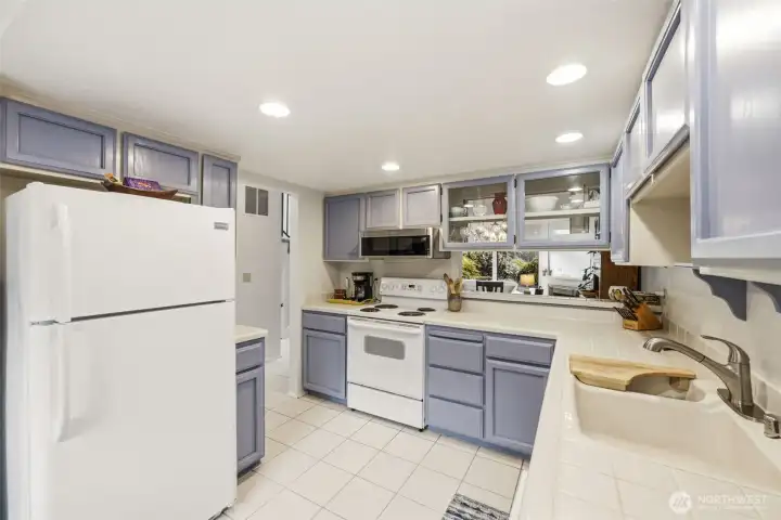 Spacious and bright kitchen. Lots of storage and counterspace with pass through to dining room.