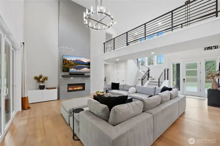 Living room showing spacious open entry 20' ceilings and catwalk above
