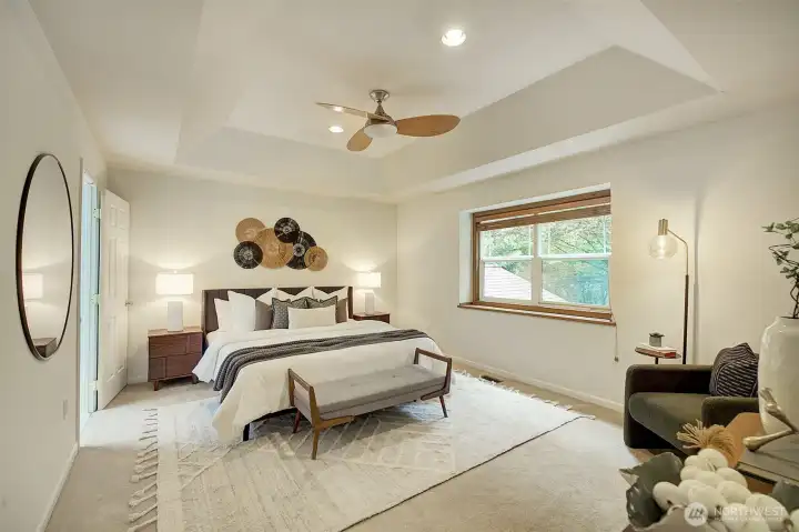 Primary bedroom with two walk-in closets and three quarter bath.