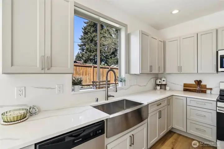 Quartz counters and backsplash with soft close cabinets.