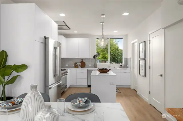 Experience culinary delight in this modern kitchen, featuring sleek countertops, state-of-the-art appliances, and abundant natural light.