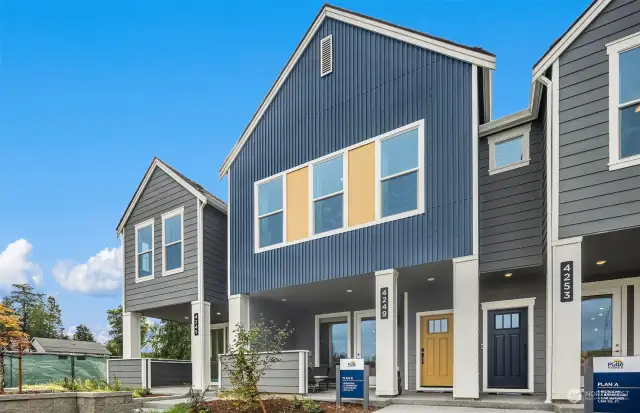 Model home Unit B in middle, showing gathering room, primary suite, and flex space windows