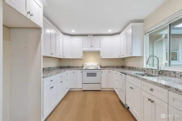 beautiful kitchen with new cabinets, granite counters and new appliances.