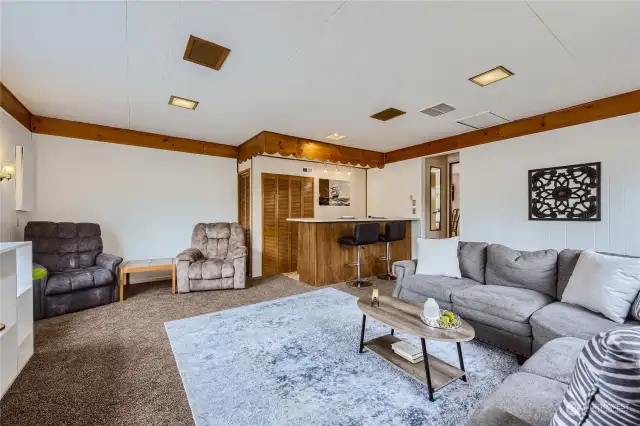 Garage converted into a large family room with wet bar and mini fridge