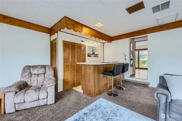 Family room wet bar area and exit into dining/reading area