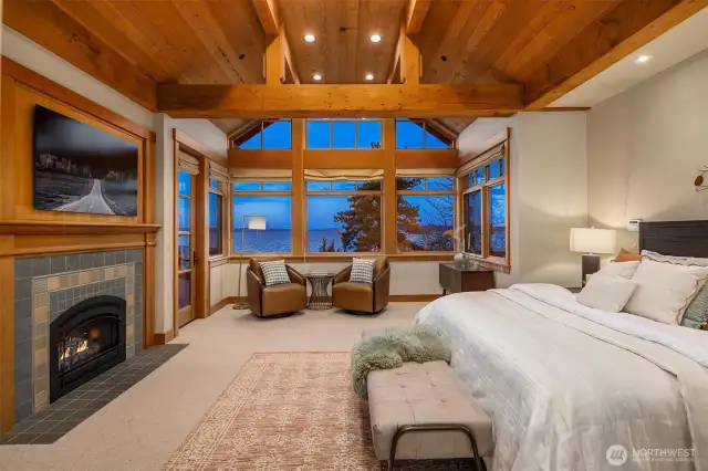Incredible main floor owners' suite- Vaulted ceilings, lake views, private door to the deck & cozy, gas fireplace.